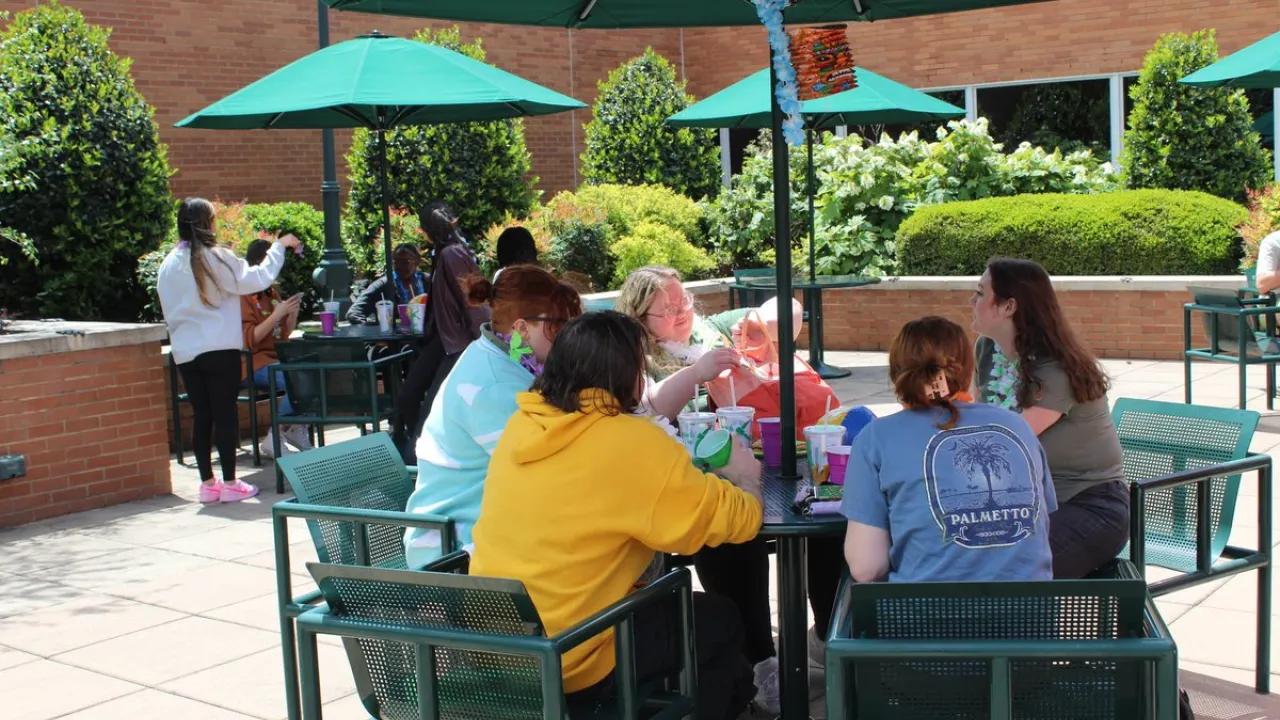 Students sitting at a table outside of the Cone University Center