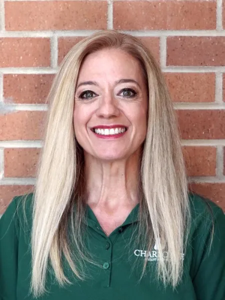 Kelly Lusco Merges smiling with a UNC Charlotte polo