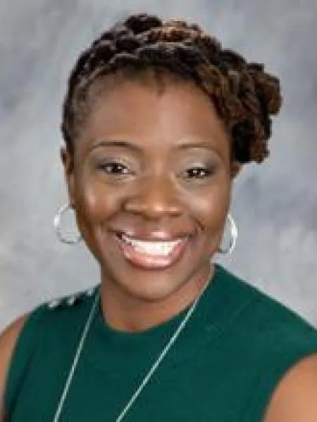 Michelle Guobadia smiling in a green dress