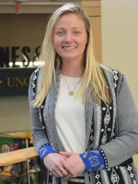 Morgan Meehan leaning on a handrail in the Popp Martin Student Union